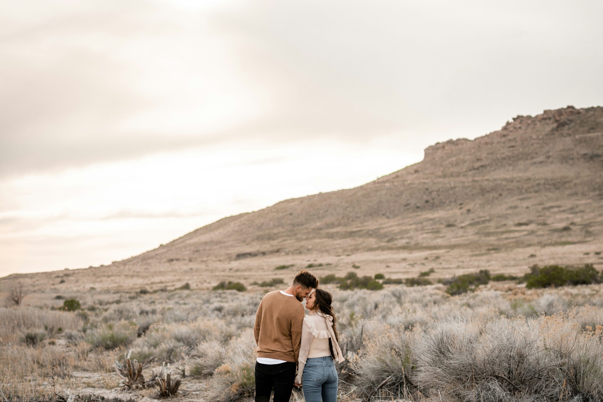 Couple Embracing in Quiet Desert Landscape – Reconnection and Intimacy