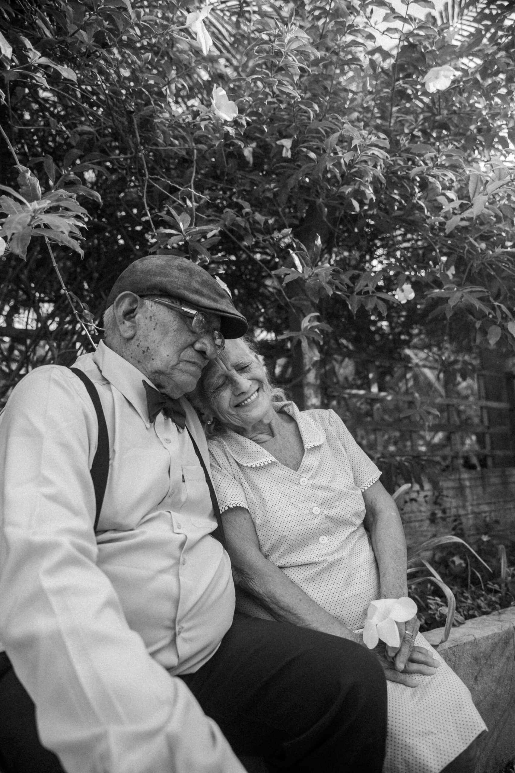 Elderly couple sitting close together, sharing a quiet moment of love and remembrance, symbolizing comfort and connection in grief counselling at Heartsprout Therapy in Toronto and Vancouver.